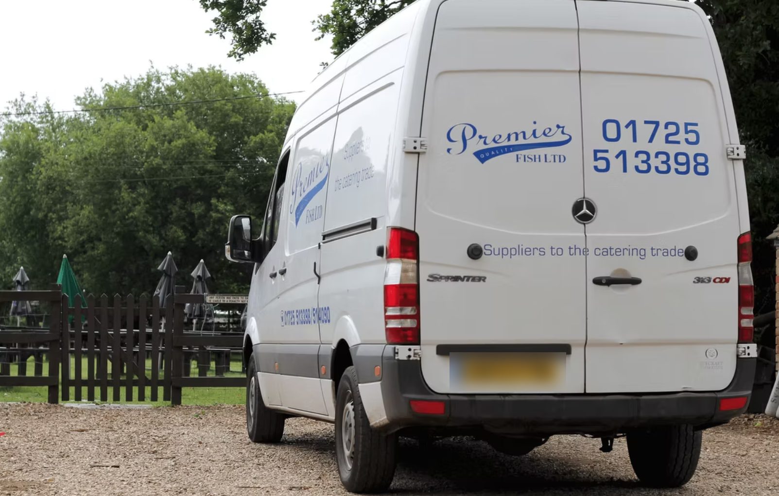 A Premier Fish delivery van, a white Mercedes Sprinter with the company name and phone number on the back
